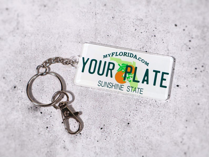 Unique gift idea for car lovers — custom license plate keychain available in all 50 U.S. states. Personalize with your name or message for a one-of-a-kind accessory. Perfect for birthdays, graduations, or new drivers. Acrylic design with metal chain ensures durability and shine. A fun and collectible replica plate keychain to celebrate your favorite destination.