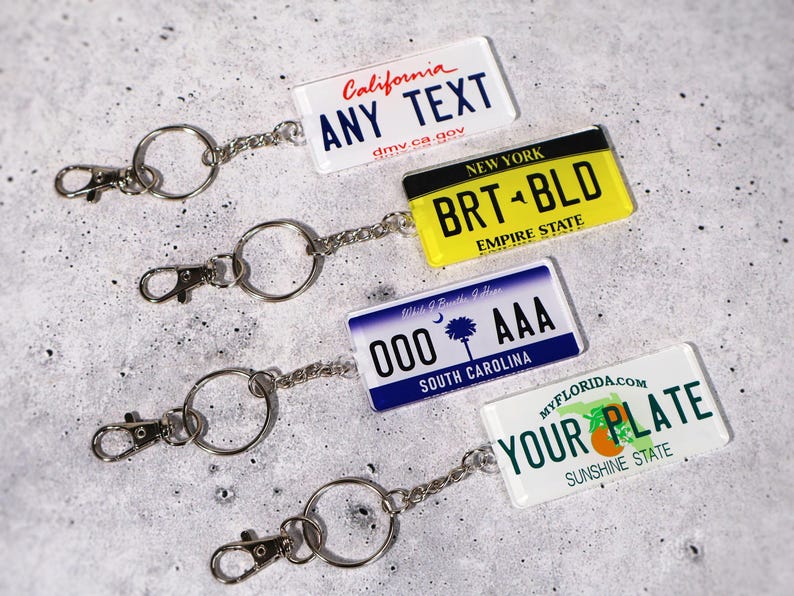 Custom license plate keychain designed to look like real 50-state tags. Personalized with any name, phrase, or number for a fun car lover’s gift or driver’s accessory. Made from durable acrylic with glossy finish and metal chain, perfect as a unique replica tag for keys or bags. Great gift idea for new drivers, car enthusiasts, or anyone who loves custom auto-themed accessories.