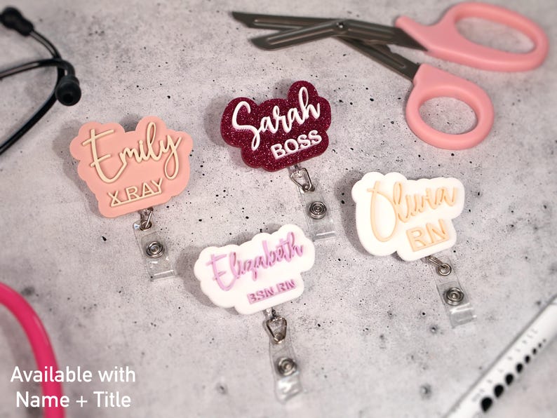 Two-line custom acrylic badge reels with name and title engraving such as RN, BSN, and X-RAY. Personalized retractable ID holders for nurses, doctors, and medical staff. Features 360° alligator clip and retractable cord up to 25 inches. Shown in blush, glitter red, and white pastel combinations. Perfect nurse week gift or custom name badge reel for healthcare professionals.