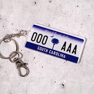 Personalized license plate keychain for new drivers — customizable with your text, initials, or numbers. Acrylic tag replicates real U.S. license plates for a fun, authentic look. Ideal car accessory and thoughtful gift for teens, graduates, or first-time car owners. A small but memorable keepsake for anyone celebrating a new car or license milestone.