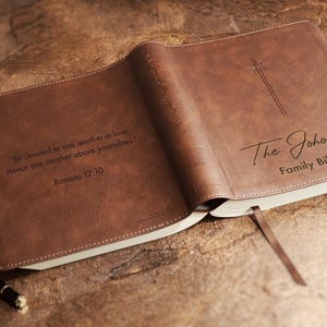 Custom engraved leather NIV Family Bible displayed as a wedding guest book for signatures and blessings. Personalized wedding Bible guestbook for religious wedding, Christian wedding shower gift, anniversary gift, family heirloom keepsake.