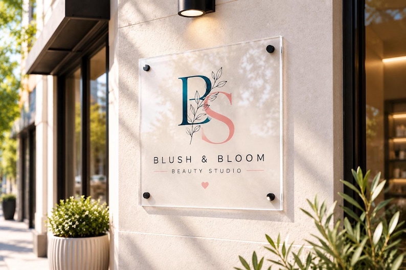 Custom square acrylic business sign with full-color UV printed logo and silver mounting hardware displayed behind a modern reception desk