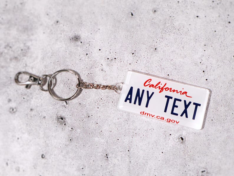 Custom plate keychain available in 50 state styles. Add your own name, initials, or phrase to create a one-of-a-kind keyring. Acrylic material with glossy finish gives a realistic license look. Great for car lovers, new drivers, or travel enthusiasts who want to show off their favorite state. A stylish, personalized, and functional car accessory gift.