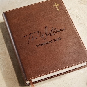 Elegant personalized family Bible and Bible guest book with custom cover text, ideal for a Christian wedding or baptism keepsake.