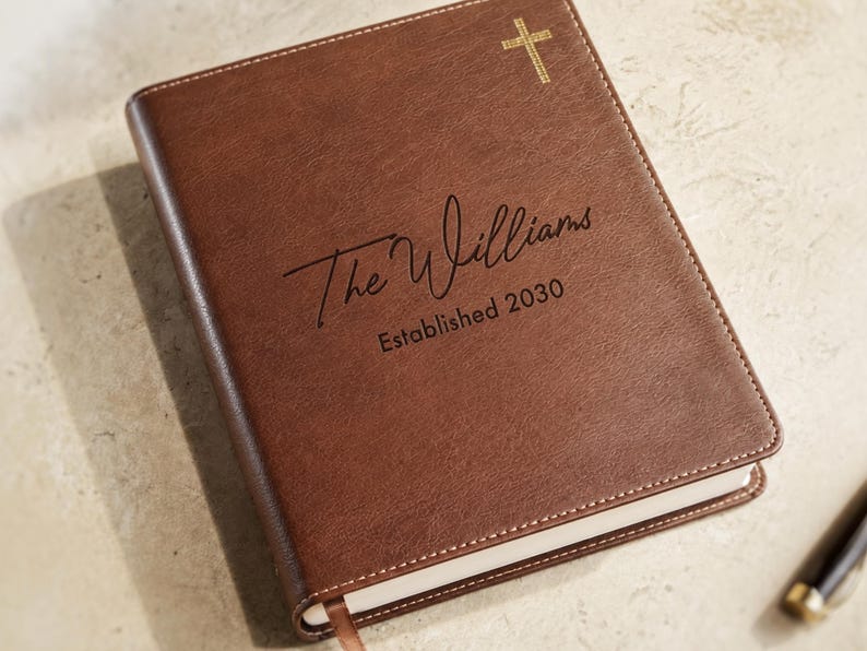 Elegant personalized family Bible and Bible guest book with custom cover text, ideal for a Christian wedding or baptism keepsake.