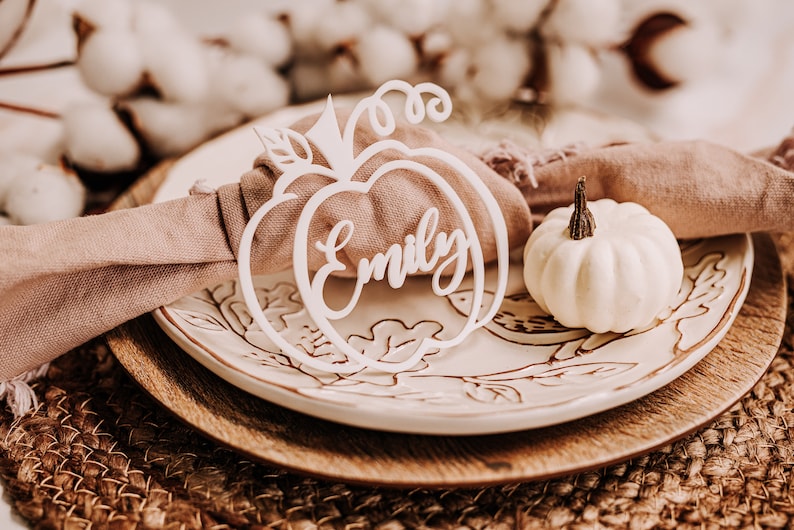 Engraved pumpkin-shaped wooden name tags designed for Thanksgiving and fall parties. These custom place cards help guests find their seats while adding a decorative seasonal element to your rustic or modern table setting.