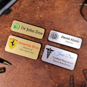 Full-color UV-printed name tag featuring a company logo and employee title on metallic acrylic backing. Professional magnetic name badge for corporate branding, employee uniforms, and office identification. Durable printed tag with vivid, scratch-resistant finish.