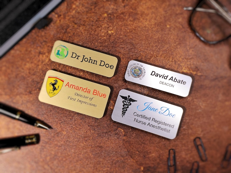 Full-color UV-printed name tag featuring a company logo and employee title on metallic acrylic backing. Professional magnetic name badge for corporate branding, employee uniforms, and office identification. Durable printed tag with vivid, scratch-resistant finish.
