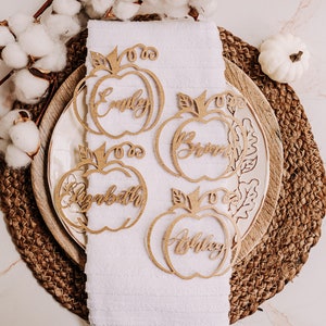 Elegant and fun pumpkin place cards for Thanksgiving and fall events. Custom engraved with guest names and available in various colors and materials to match your autumn theme, from rustic to modern decor styles.