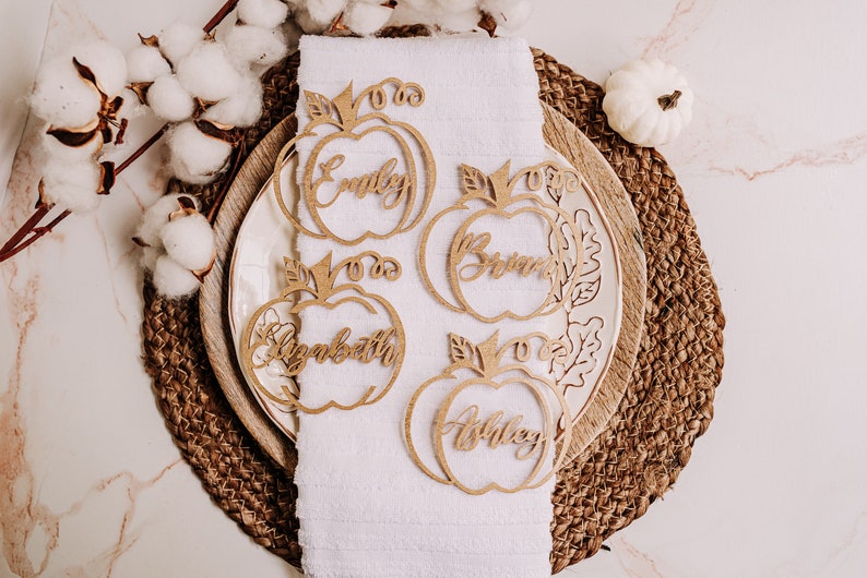 Elegant and fun pumpkin place cards for Thanksgiving and fall events. Custom engraved with guest names and available in various colors and materials to match your autumn theme, from rustic to modern decor styles.