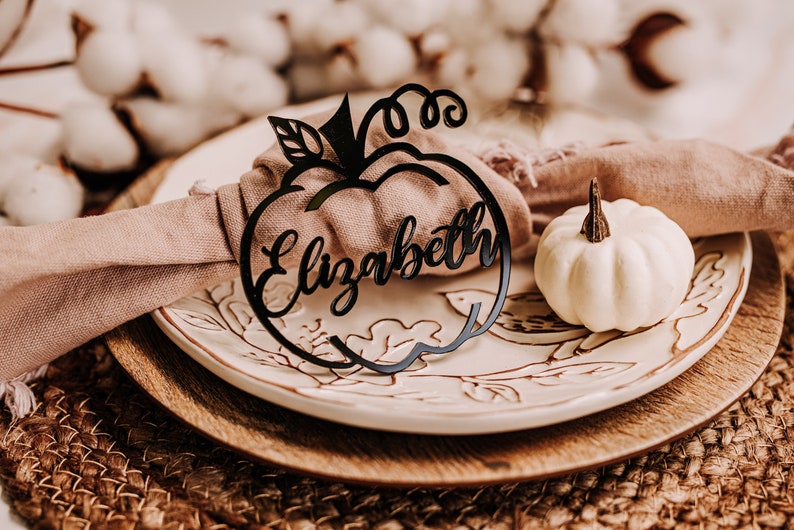 Personalized pumpkin name plates cut from Baltic birch wood for autumn gatherings, Thanksgiving dinners, or fall weddings. Guests love these festive table name tags that double as keepsakes to take home and remember the celebration.