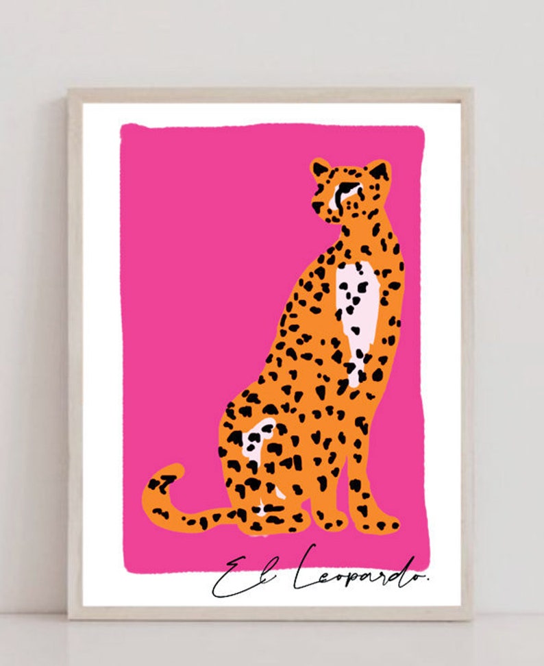May include: A digital illustration of a cheetah sitting on a bright pink background. The cheetah is orange with black spots and has a white patch on its chest. The text "El Leopardo" is written in black cursive at the bottom of the image.