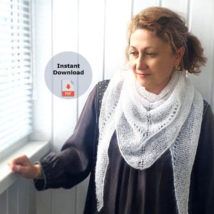 May include: A woman wearing a white lace shawl with a delicate pattern. The shawl is draped over her shoulders and neck. The woman is standing in front of a window with blinds. The text "Instant Download PDF" is visible in a circle.