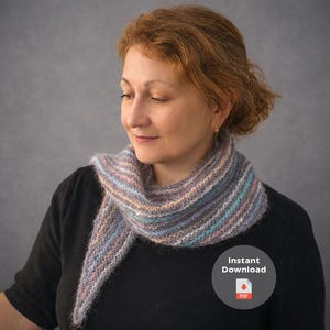 May include: A knitted scarf in shades of grey, blue, and peach, worn around the neck. The scarf has a striped pattern. The image includes a small circular graphic with the words "Instant Download" and a PDF icon.