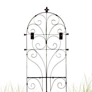 May include: Black metal garden trellis with a decorative arched top and multiple levels of curved bars. The trellis is designed to support climbing plants.