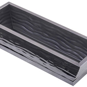 May include: A black metal planter with a wavy textured surface. The planter has a rectangular shape with a slightly curved edge. It has a raised base.