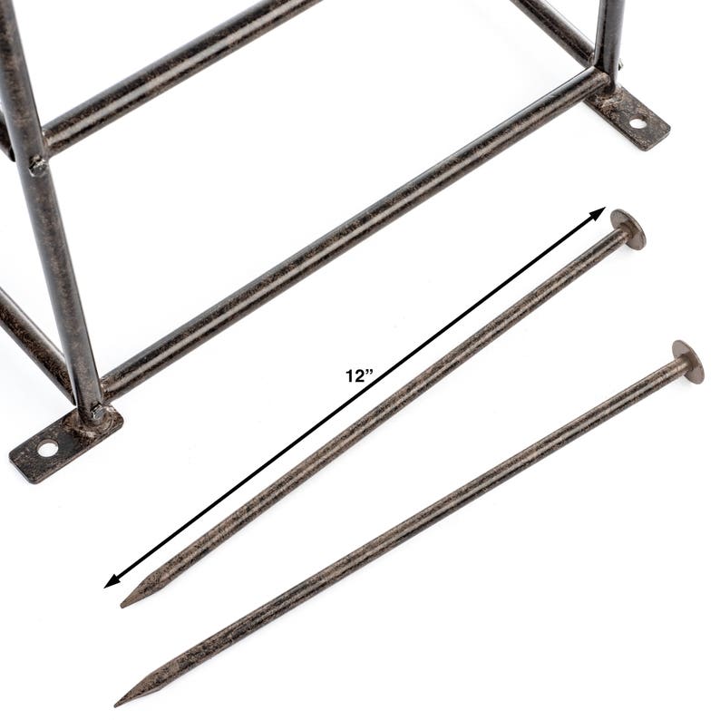 May include: A dark brown metal frame with two matching metal stakes. The stakes are pointed at one end and have a flat circular head at the other. A dimension line indicates the stakes are 12 inches in length. The frame has mounting tabs.