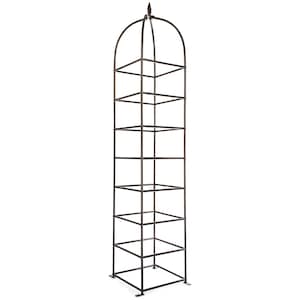May include: A tall, dark brown metal garden obelisk trellis featuring a square-based frame with multiple horizontal rungs and a rounded, arched top section that culminates in a pointed finial. The structure is designed with a grid pattern.