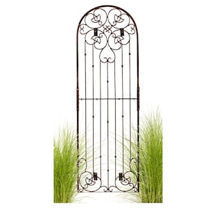 May include: A decorative metal garden trellis with a brown finish and an arched top. The trellis has a scrolled design and is perfect for climbing plants.