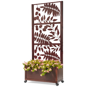 May include: A brown metal privacy screen with a built-in planter box. The screen features a cut-out leaf design. The planter box is filled with pink flowers. The screen is on wheels.