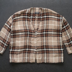 May include: A brown and beige plaid cardigan with a v-neck.