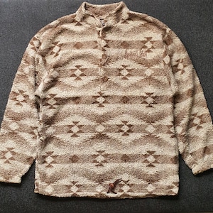 May include: A brown and white patterned fleece pullover with a button-up front.