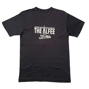 May include: A black short-sleeve t-shirt featuring white text on the chest that reads ONWARD SUPER ENTERTAINMENT THE ALFEE WITH JEAN PAUL GAULTIER. The shirt has a crew neckline and a standard fit, with the graphic centered on the front torso area.