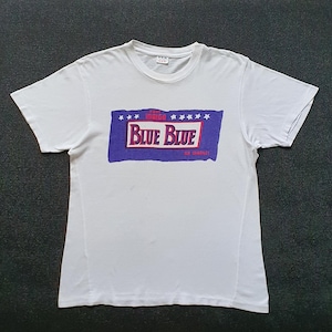 May include: White t-shirt with a blue and red graphic that says "Blue Blue" with stars around the graphic.