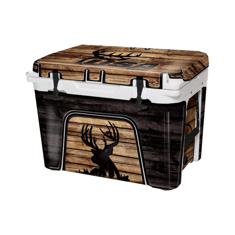 May include: A white cooler with a wood grain and deer silhouette design. The cooler has a black handle and a black latch.