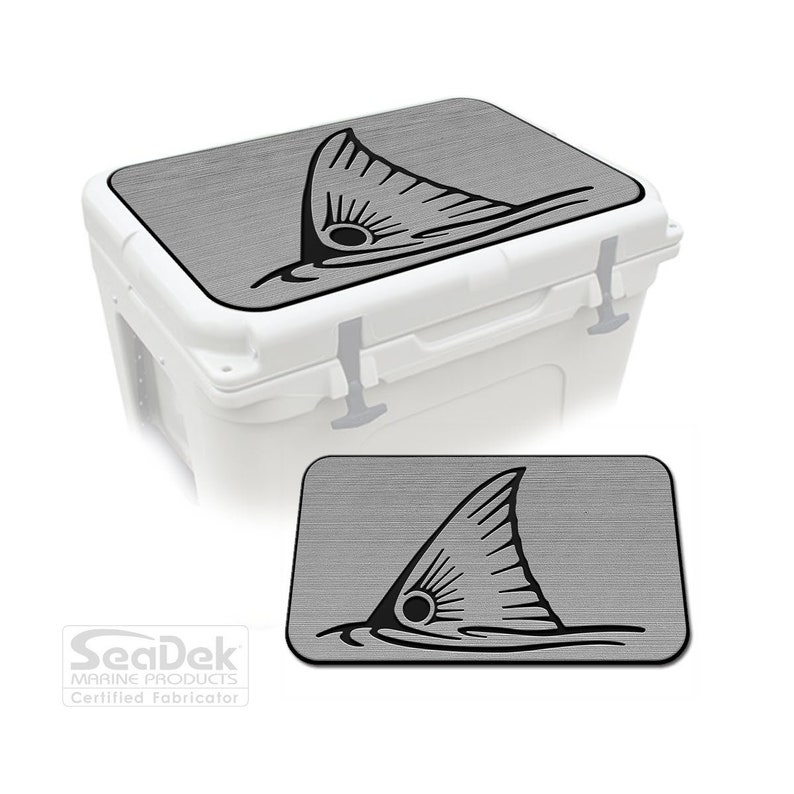 May include: Gray cooler lid with a black redfish tail graphic. The lid is made of a textured material. SeaDek Marine Products Certified Fabricator.