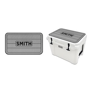 May include: A gray Yeti cooler with a custom lid featuring the word "SMITH" in black lettering. The lid has a wood-grain pattern.