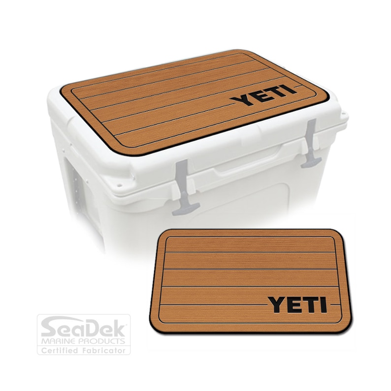 May include: A brown and black SeaDek non-slip pad with the word "YETI" printed on it. The pad is designed to fit on top of a YETI cooler.