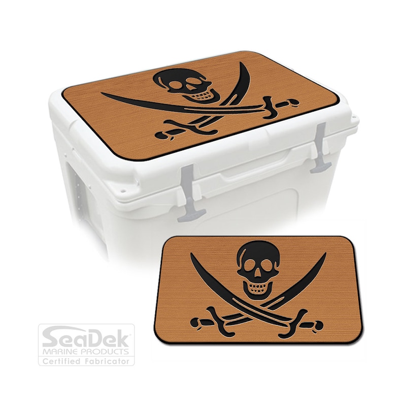 May include: A brown and black cooler lid with a pirate skull and crossbones design. The lid is made of a textured material and has a black border. SeaDek Marine Products Certified Fabricator.