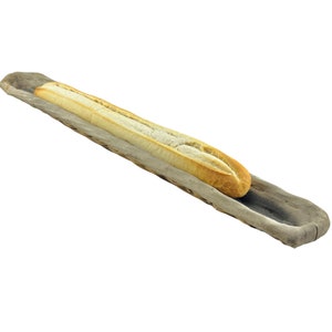 May include: A long loaf of white bread in a rustic wooden bread basket.