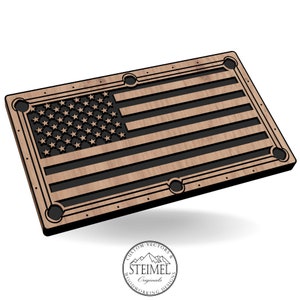 May include: A wooden American flag pool table with a black border and six pockets. The flag is made of wood with a black inlay for the stars and stripes.