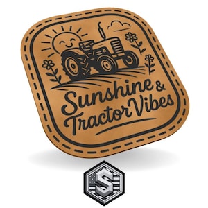 May include: A brown leather patch with a black stitched border. The patch features a smiling sun, a tractor, flowers, and the words "Sunshine & Tractor Vibes" in a script font. A silver and grey logo is at the bottom.
