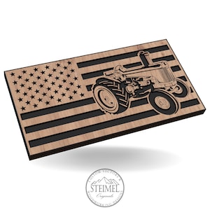 May include: A wooden cutout of a tractor in front of an American flag. The tractor is in the center of the image and the flag is behind it. The flag is made of wood and has a black background with white stripes and red stars.