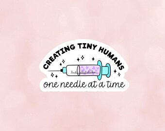 May include: A white sticker with a blue syringe filled with purple hearts and the text "Creating Tiny Humans One Needle at a Time".