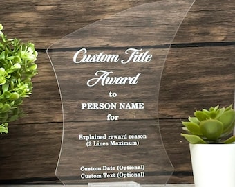 Puede incluir: Premio de acrílico transparente con una forma curva única. El texto blanco dice "Custom Title Award to PERSON NAME for", seguido de espacio para el motivo del premio, la fecha y texto personalizado. El premio se apoya en una base rectangular transparente.
