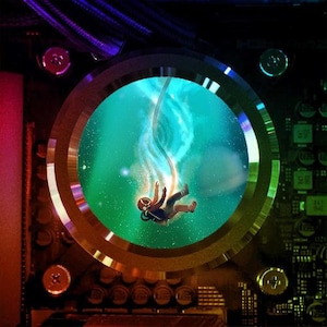 May include: A digital illustration of an astronaut floating in space, surrounded by a swirling blue and green nebula. The astronaut is wearing a white spacesuit with a black helmet and is holding a blue rope. The image is framed by a circular metal ring with a rainbow-colored border.