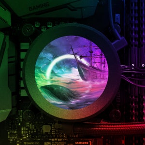 May include: A close-up of a computer motherboard with a circular window revealing a colorful illustration of a ship sailing on a starry sea with a whale swimming in the water below.