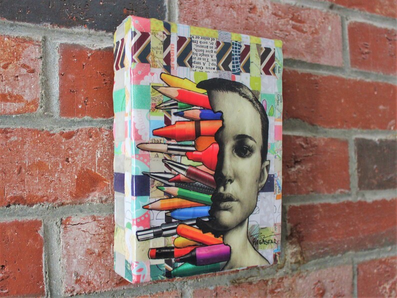 May include: A colorful collage artwork featuring a person's face with a variety of colored pencils and markers sticking out of their head. The background is a patchwork of colorful patterns.