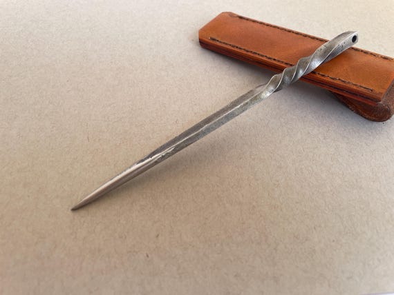 A hand-forged hardened tool-steel scribe/awl/pick — the kind of beautifully simple, bombproof EDC tool that leather workers, makers, and craftsmen will reach for every single day.