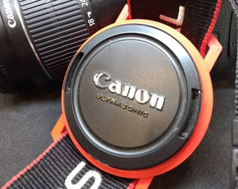 Lens Cap Holder for DSLR camera caps 37-98mm in size and in a range of colours. Fully customisable.