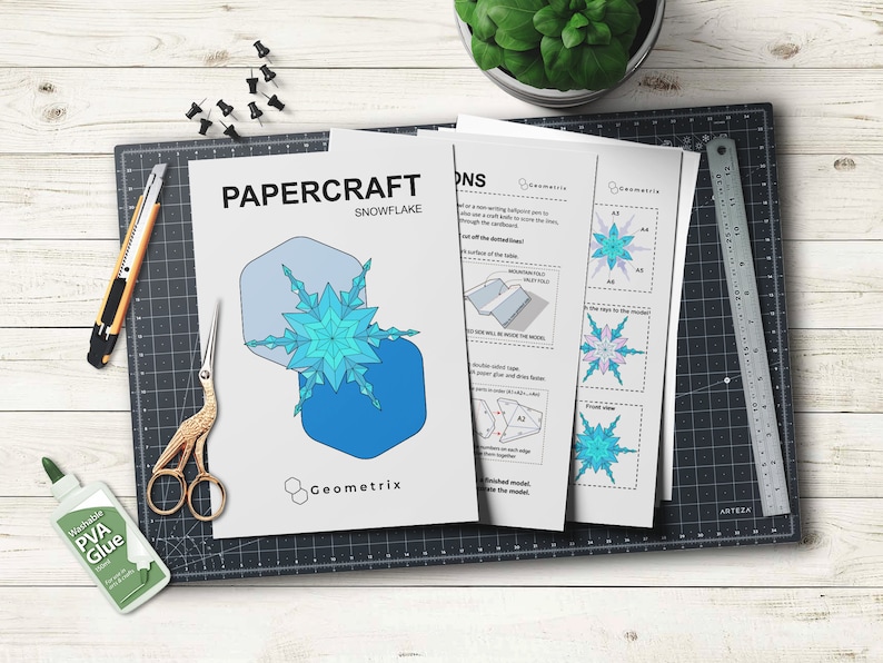 May include: Papercraft snowflake template with instructions. The template features a blue and white snowflake design with geometric shapes. The instructions include diagrams and text.
