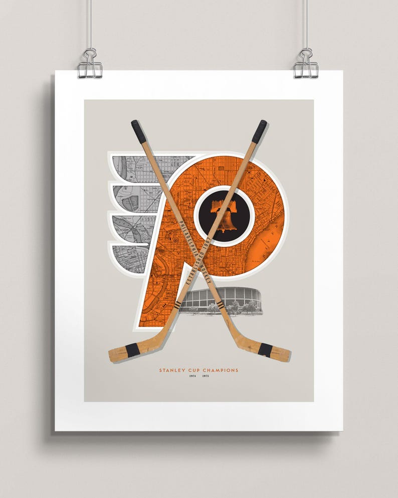 May include: A vintage-style print featuring the Philadelphia Flyers logo, a stylised orange "P" with wings, overlaid on a map of Philadelphia. Two crossed hockey sticks are positioned behind the logo, with the text "STANLEY CUP CHAMPIONS 1974 1975" below.