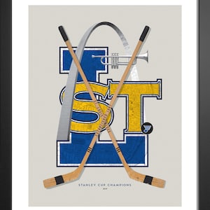 May include: A blue and yellow graphic of the letters "ST" with a map of St. Louis, Missouri inside the letters. The letters are surrounded by a silver arch, and two hockey sticks are crossed behind the letters. The text "STANLEY CUP CHAMPIONS 2019" is below the graphic.