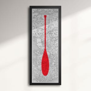 May include: A red paddle silhouette on a vintage map print. The paddle is centred on the map and fills the entire height of the image. The map is in black and white and shows a detailed geographical area.