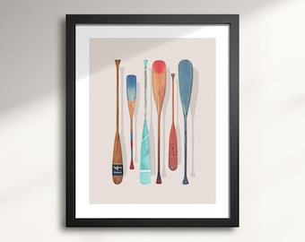 May include: A framed print of a watercolor painting of six wooden paddles with different colors and designs. The paddles are hanging on a wall.