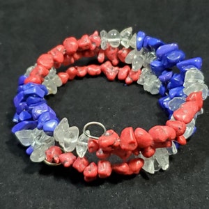 May include: A multi-strand bracelet made with red, white, and blue gemstone chips. The bracelet is made with a wire wrap technique.